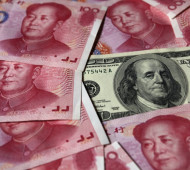 a-100-banknote-is-placed-next-to-100-yuan-banknotes-in-this-picture-illustration-taken-in-beijing-oct-16-2010