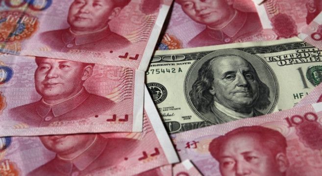 a-100-banknote-is-placed-next-to-100-yuan-banknotes-in-this-picture-illustration-taken-in-beijing-oct-16-2010